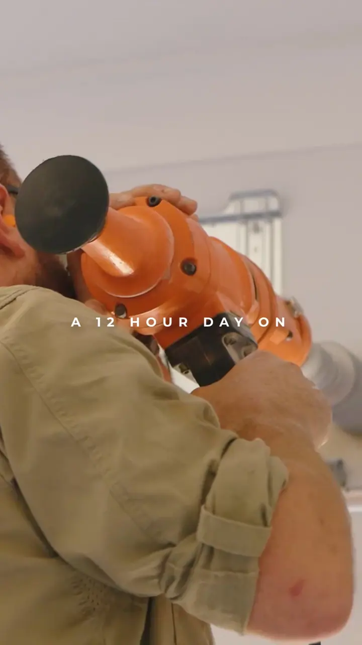 A tradesperson on the tools with a rotary hammer, from the member video