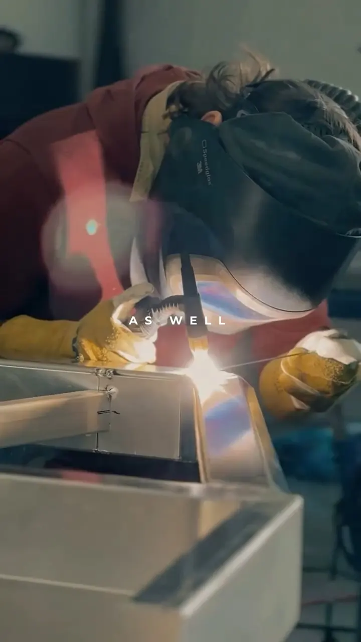 A tradesperson welding in a workshop, from the member video